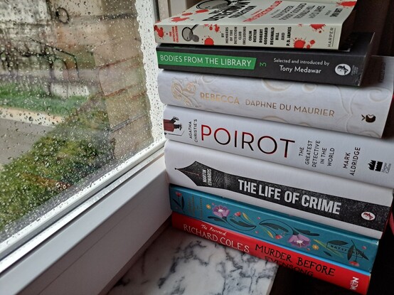 A pile of books by the window