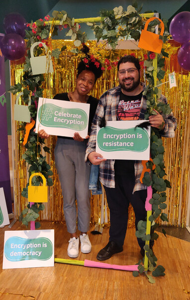 Two persons holding signs celebrating encryption reading "Encryption is resistance", "Celebrate Encryption", "Encryption is democracy".