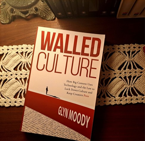 The book Walled Culture on top of a table lightened by an old lamp