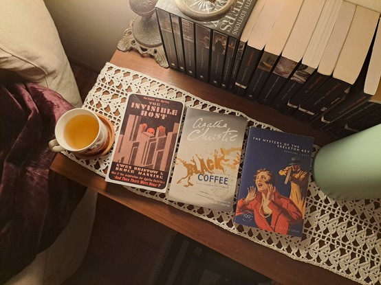 The books with a cup of tea over a side table