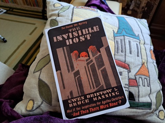 The book The Invisible over a pillow