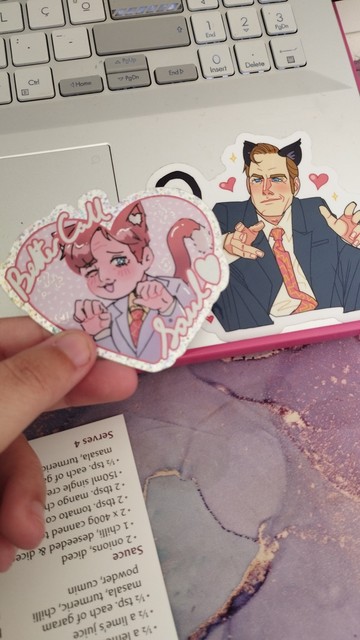 Low quality photo of my two stickers of Saul Goodman the cat boy, nya