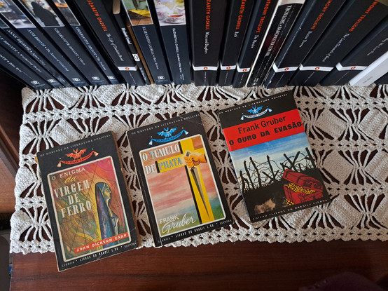 Three books showing the covers over a crochet cloth with books spines at the back