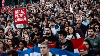 Foto de uma manifestação onde se vê um cartaz a dizer NÃO AO PACOTE LABORAL
