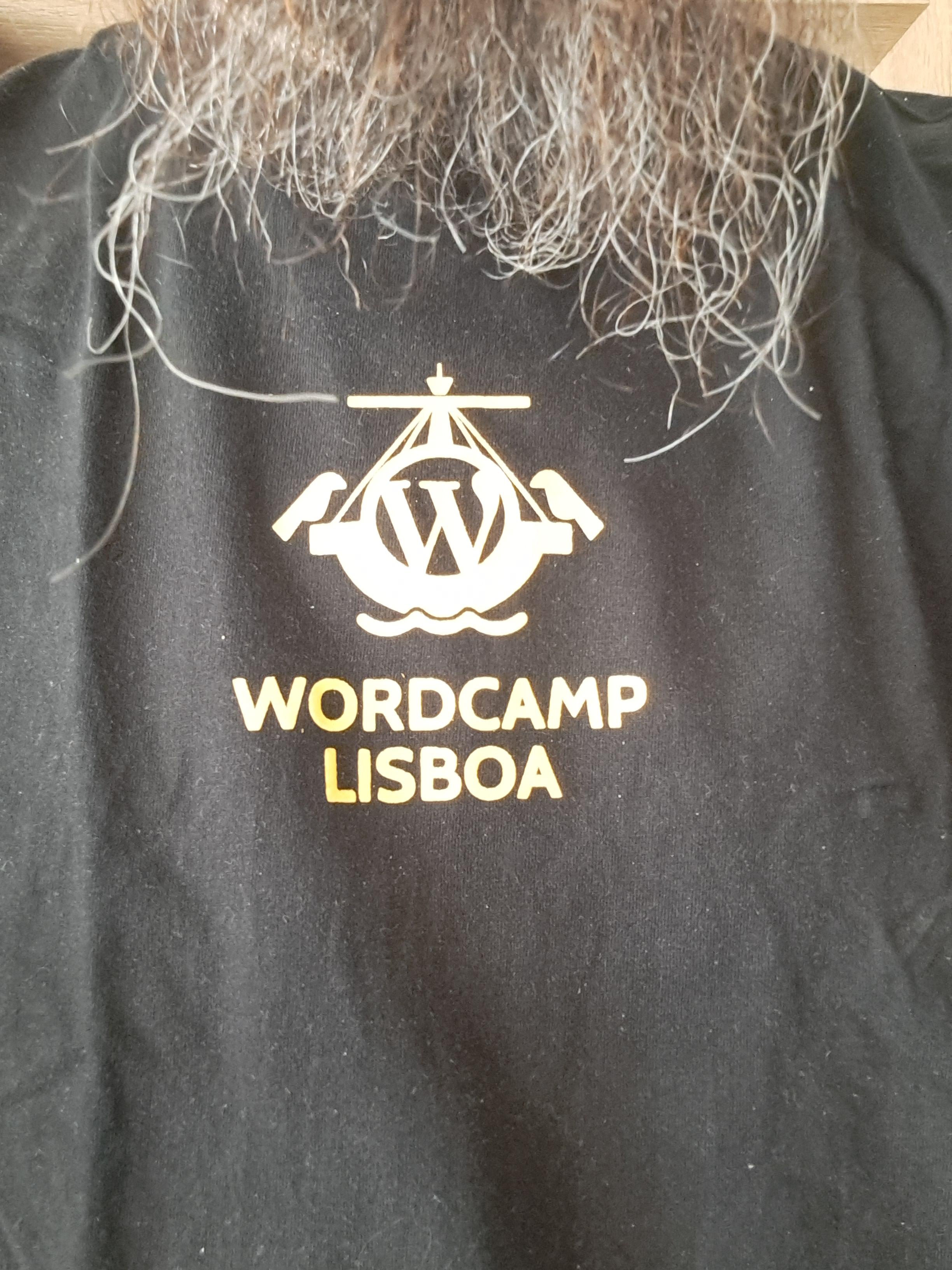 The first t-shirt of this saga that I am actually wearing for the picture, even we have a storm ongoing and might be too cold for it yet... a t-shirt from Wordcamp Lisboa 2019, chosen this week as an excuse for a reminder that Wordcamp Portugal 2026 is in less than a month!