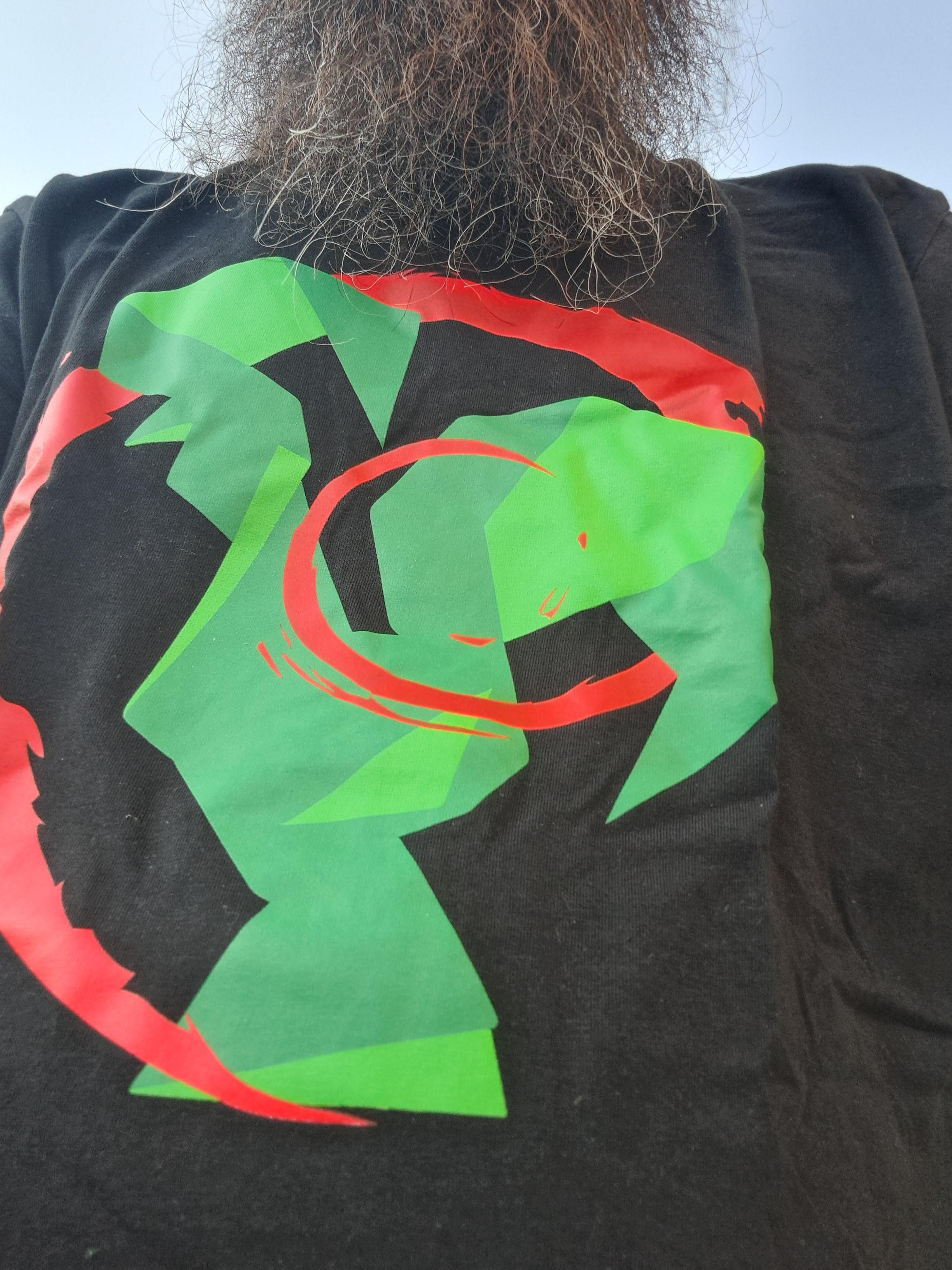 To celebrate Debian Day, today I wear a black shirt with Debian's swirl surrounding the Portuguese Barcelos cock, a t-shirt from a minidebconf that happened in Portugal a few years ago