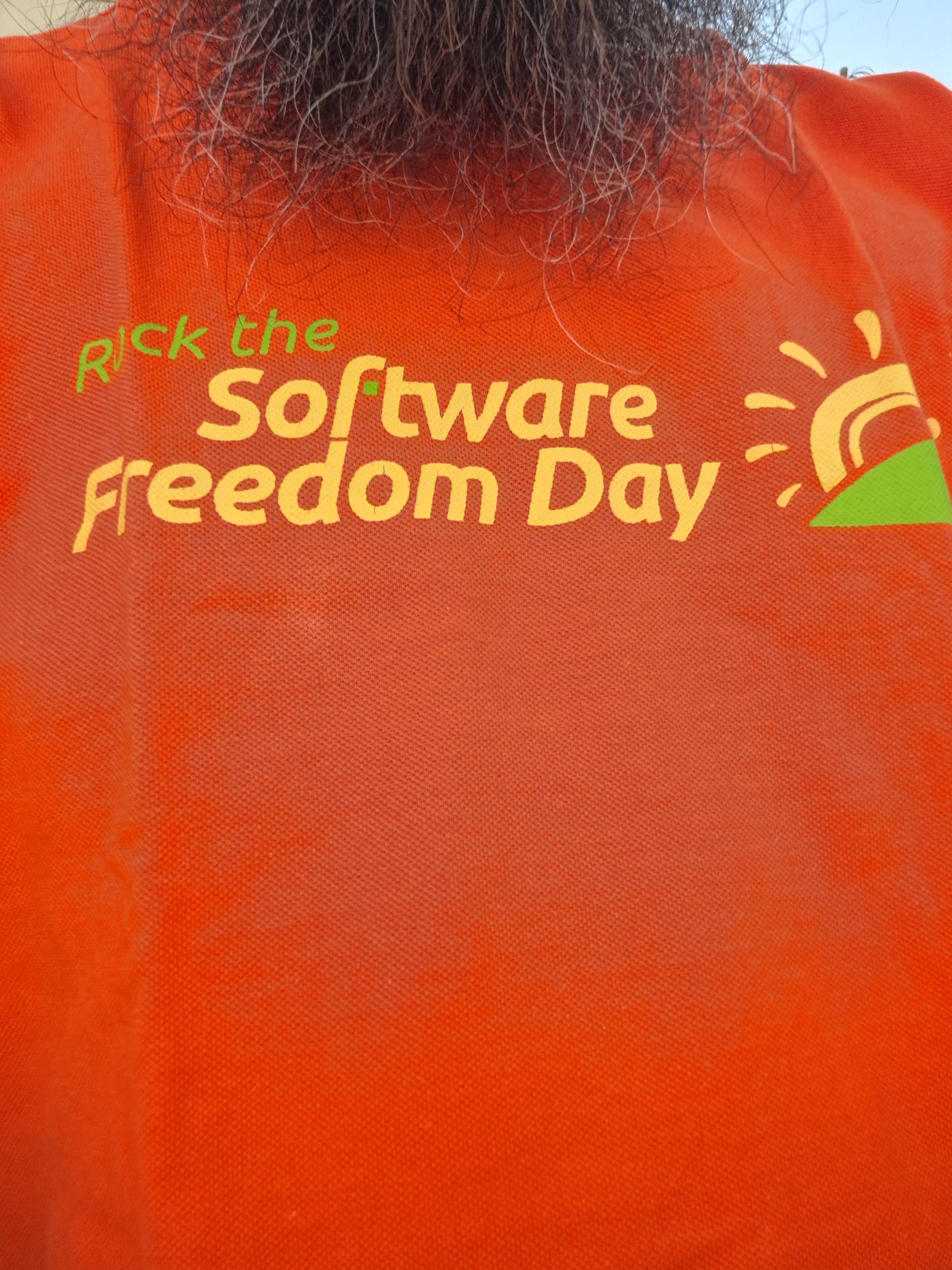 In this year's Software Freedom Day I'm sharing an orange shirt saying "Rock the Software Freedom Day", with SFD's logo which is an yellow sun rising (or setting?) behind a green hill
